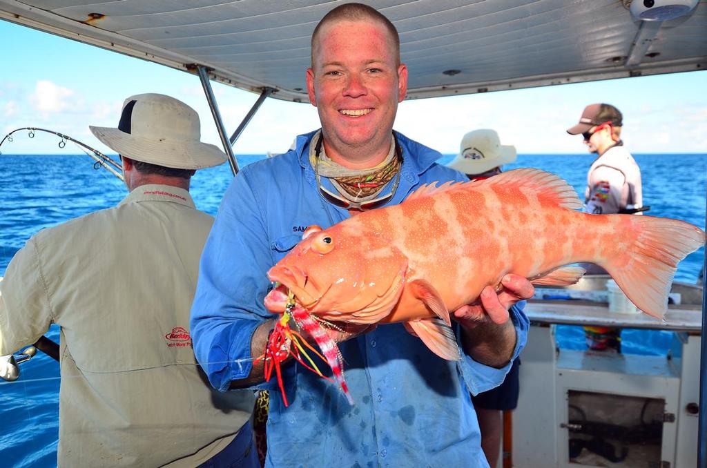 Sam with a nice trout caught when he dropped down an octo jig rigged with a saltwater fly. © Lee Brake